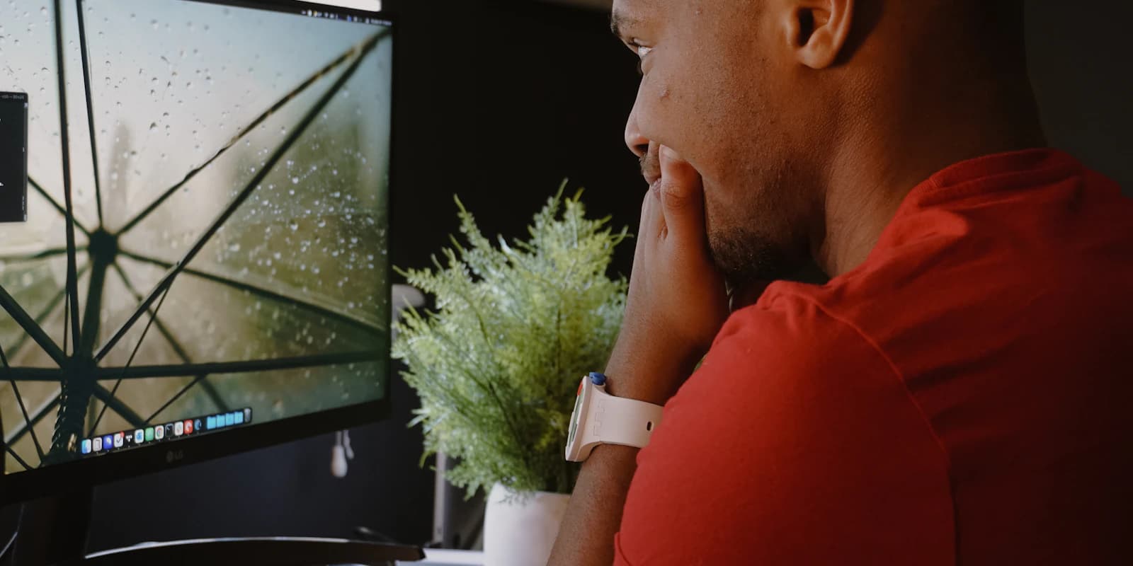 A professional studying information on a large monitor before making a call
