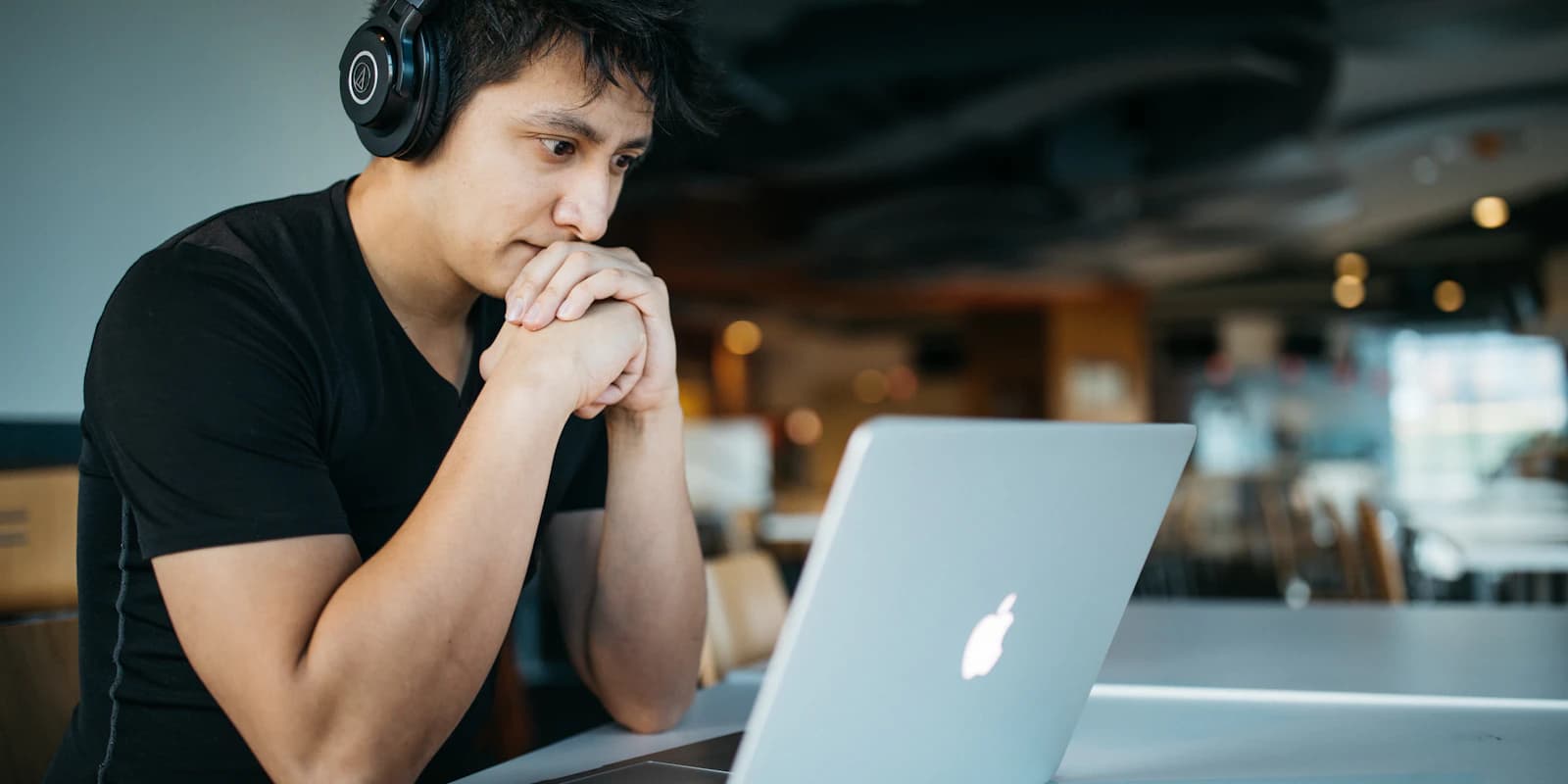 A candidate with headphones working calmly through an online assessment on a laptop